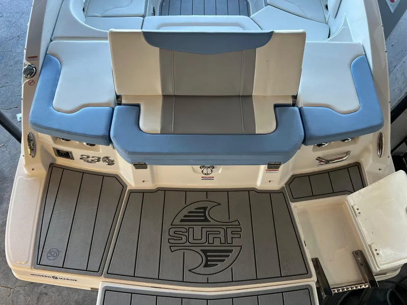Slide: The Image of 2022 Chaparral 23 Surf boat interior with cushioned seating and Surf logo. - 22