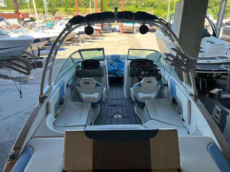 Slide: The Image of 2022 Chaparral 23 Surf boat interior with seating and dashboard. - 23