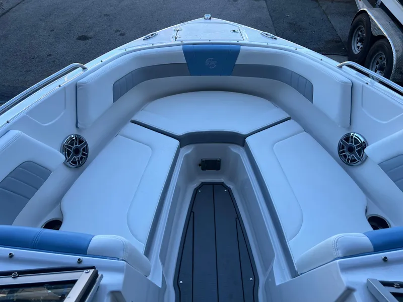 Slide: The Image of 2022 Chaparral 23 Surf boat interior with white and blue seating. - 3
