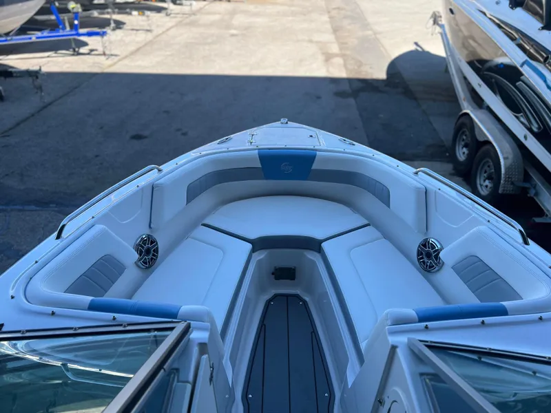 Slide: The Image of 2022 Chaparral 23 Surf boat interior with spacious seating and speakers. - 6
