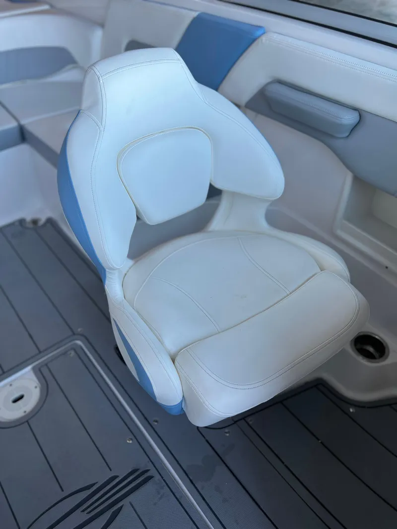 Slide: The Image of 2022 Chaparral 23 Surf boat interior with white and blue seating. - 7