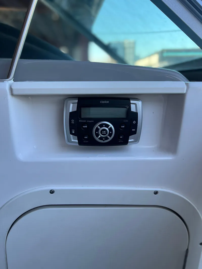 Slide: The Image of 2022 Chaparral 23 Surf boat dashboard with stereo system. - 9