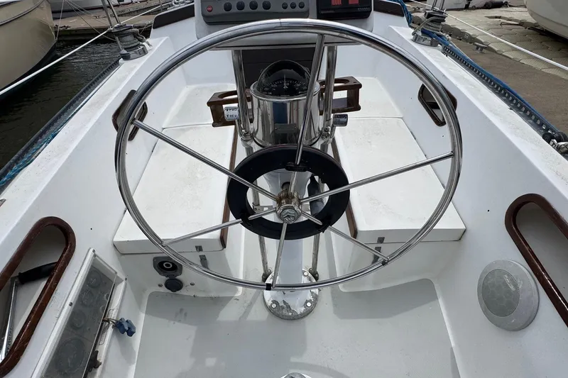 Slide: The Image of Cockpit of a 1986 Catalina 38 sailboat with a stainless steel steering wheel. - 15