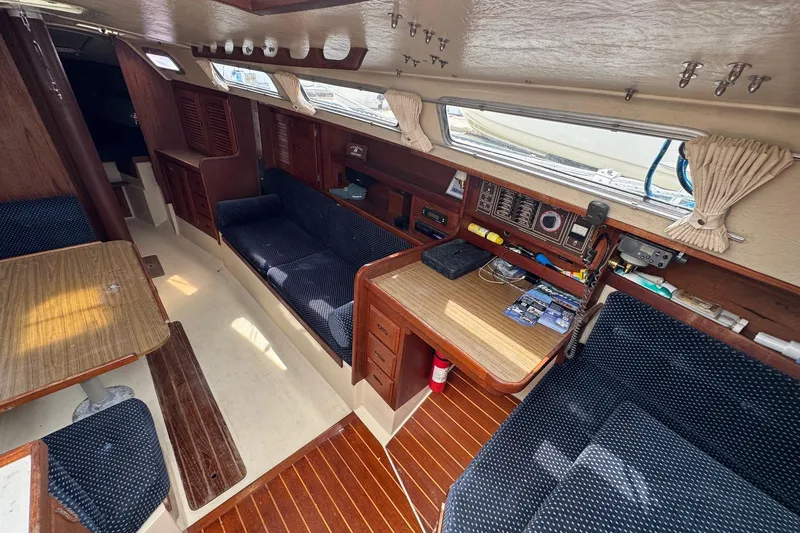 Slide: The Image of Interior of a 1986 Catalina 38 sailboat with wood accents and navy seating. - 19