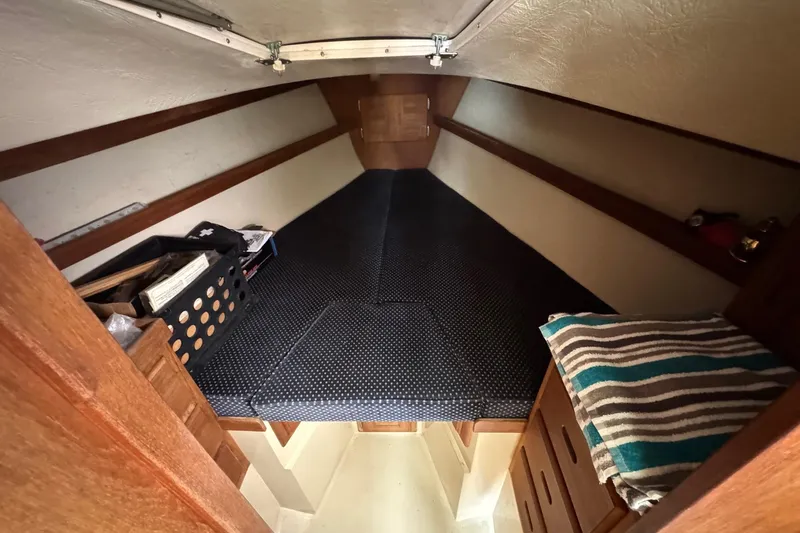 Slide: The Image of Cozy cabin interior of a 1986 Catalina 38 sailboat with storage and bedding. - 20