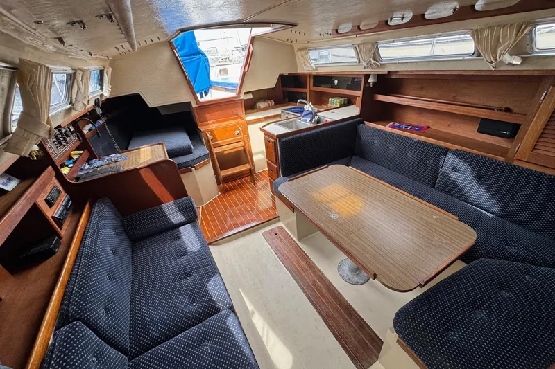 Slide: The Image of Interior of 1986 Catalina 38 sailboat with cozy seating and wooden finishes. - 21