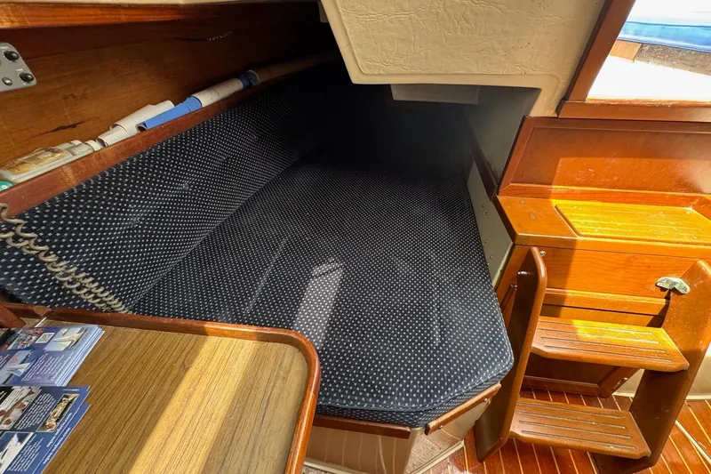 Slide: The Image of Cozy cabin interior of 1986 Catalina 38 sailboat with wooden furnishings and polka dot bedding. - 23
