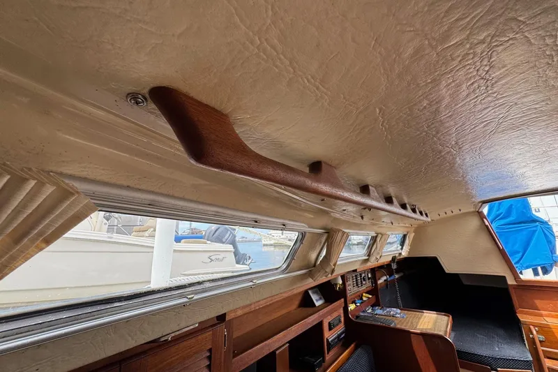 Slide: The Image of Interior of 1986 Catalina 38 sailboat, featuring wood accents and windows. - 27
