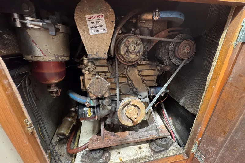 Slide: The Image of Engine compartment of a 1986 Catalina 38 sailboat, showing belts and components. - 32