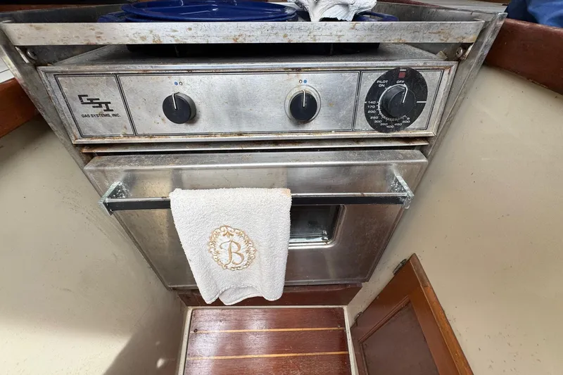 Slide: The Image of 1986 Catalina 38 yacht kitchen with GSI gas oven and embroidered towel. - 33