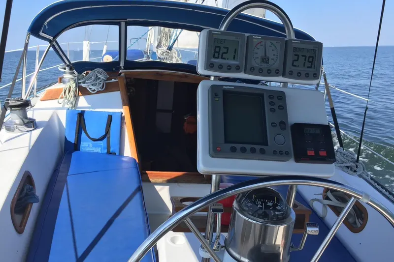 Slide: The Image of Cockpit of 1986 Catalina 38 sailboat with navigation instruments and blue seating. - 34