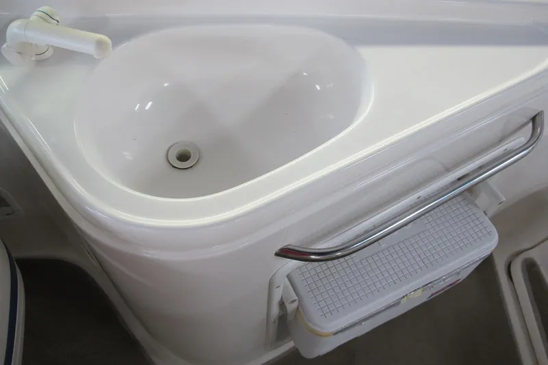 Slide: The Image of Chaparral 230 SSi 2000 boat sink with faucet and storage compartment. - 12