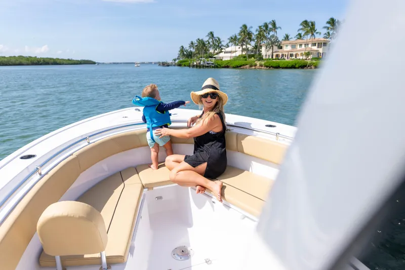 Slide: The Image of Woman and child enjoying a sunny day on a 2026 Sportsman Open 252 Center Console boat. - 3