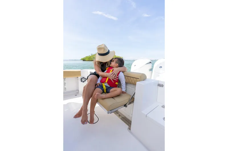Slide: The Image of Mother and child on 2026 Sportsman Open 252 Center Console boat, enjoying a sunny day. - 6