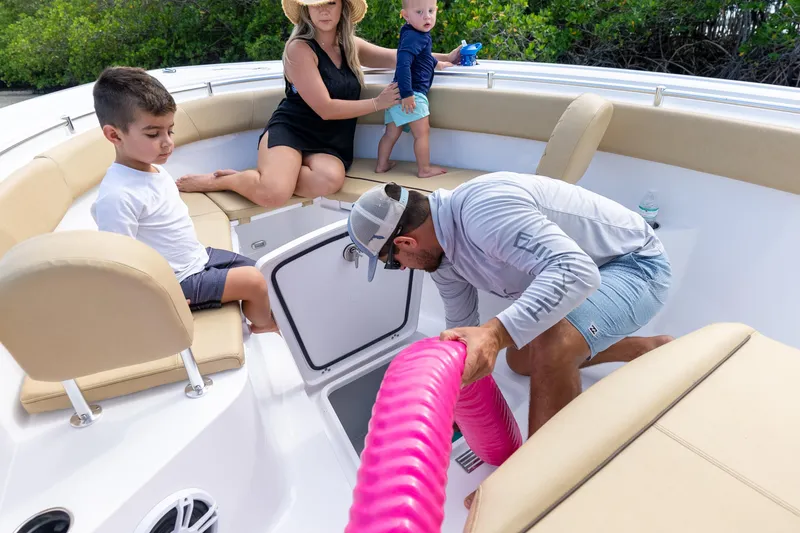 Slide: The Image of Family enjoying a day on a 2026 Sportsman Open 252 Center Console boat. - 7