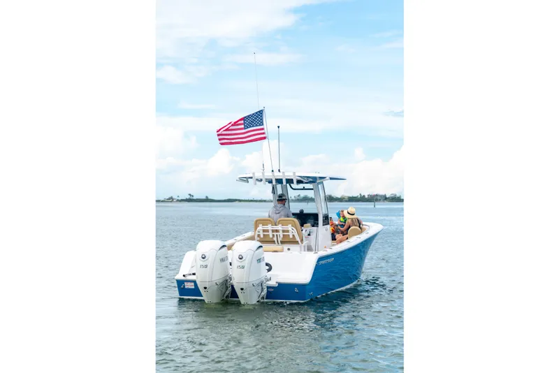 Slide: The Image of 2026 Sportsman Open 252 Center Console boat on water, American flag flying. - 8