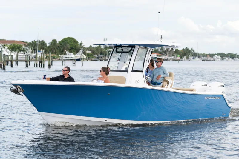 Slide: The Image of 2026 Sportsman Open 252 Center Console boat cruising on a calm waterway. - 9