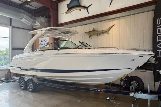 Slide: The Image of 2021 Chaparral 307 SSX boat on trailer in indoor showroom. - 1