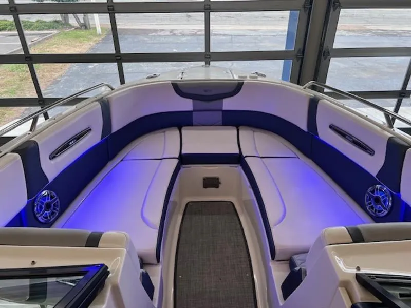 Slide: The Image of 2021 Chaparral 307 SSX boat interior with blue LED lighting and cushioned seating. - 10