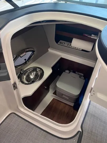 Slide: The Image of 2021 Chaparral 307 SSX boat interior with compact sink and toilet. - 17
