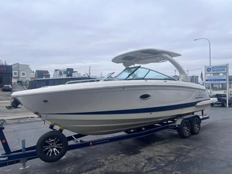 Slide: The Image of 2021 Chaparral 307 SSX boat on trailer, displayed outdoors at a marina. - 2