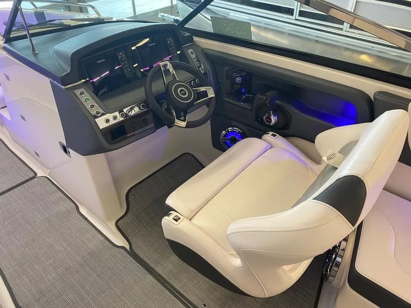 Slide: The Image of 2021 Chaparral 307 SSX boat interior with modern dashboard and comfortable seating. - 20