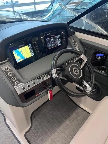 Slide: The Image of 2021 Chaparral 307 SSX boat dashboard with modern controls and navigation displays. - 21
