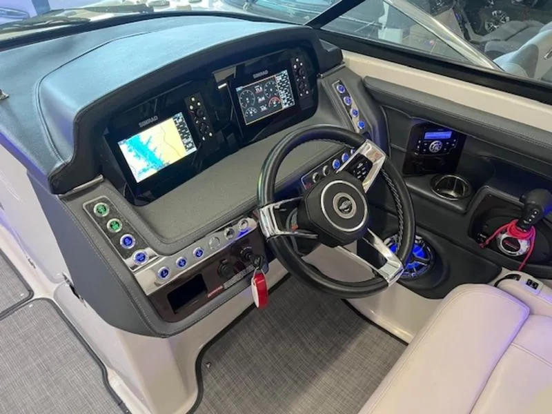 Slide: The Image of 2021 Chaparral 307 SSX boat dashboard with modern controls and navigation displays. - 22