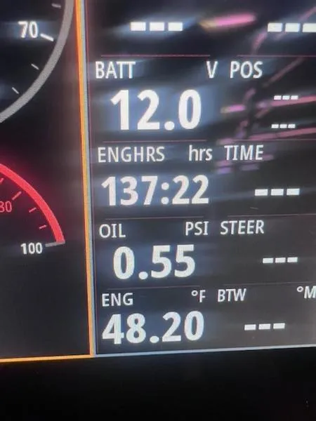 Slide: The Image of Dashboard display of a 2021 Chaparral 307 SSX showing battery, engine hours, oil pressure, and temperature. - 24