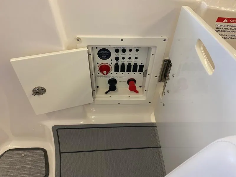 Slide: The Image of Control panel of 2021 Chaparral 307 SSX boat, featuring switches and dials. - 29