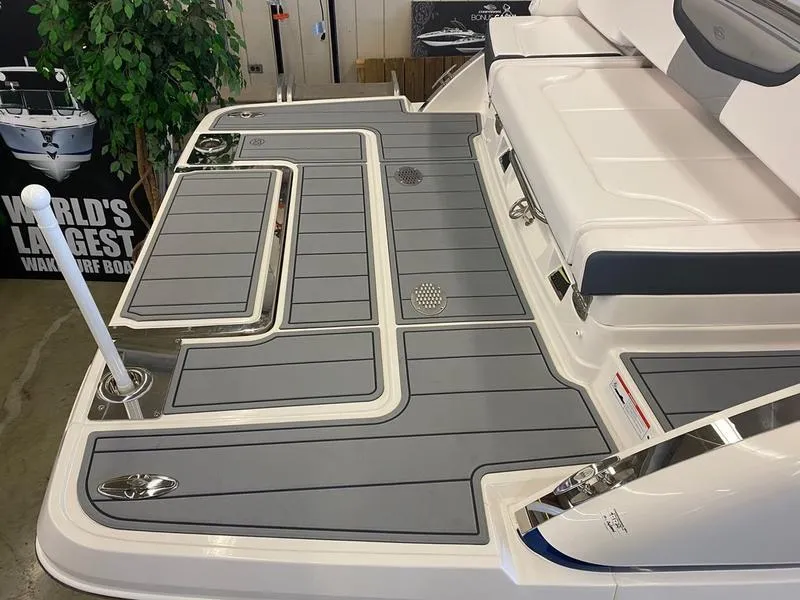Slide: The Image of 2021 Chaparral 307 SSX boat deck with sleek gray and white design. - 30