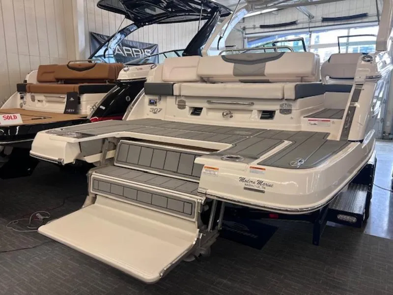 Slide: The Image of 2021 Chaparral 307 SSX boat with extended swim platform in showroom. - 34
