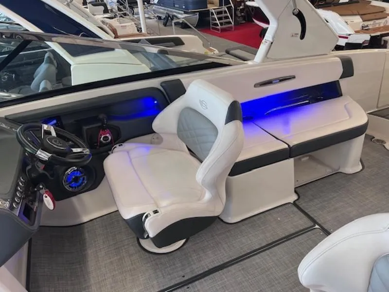 Slide: The Image of 2021 Chaparral 307 SSX boat interior with white seating and blue LED lighting. - 5