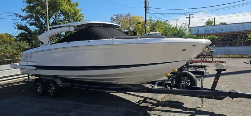 Slide: The Image of 2021 Chaparral 307 SSX boat on trailer, parked outdoors. - 6