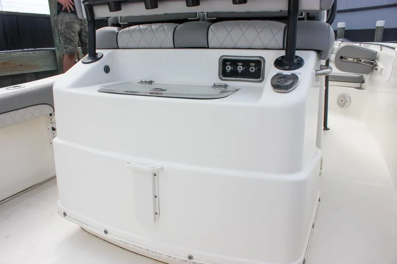 Slide: The Image of 2017 NauticStar 2602 Legacy boat interior with rod holders and livewell. - 13