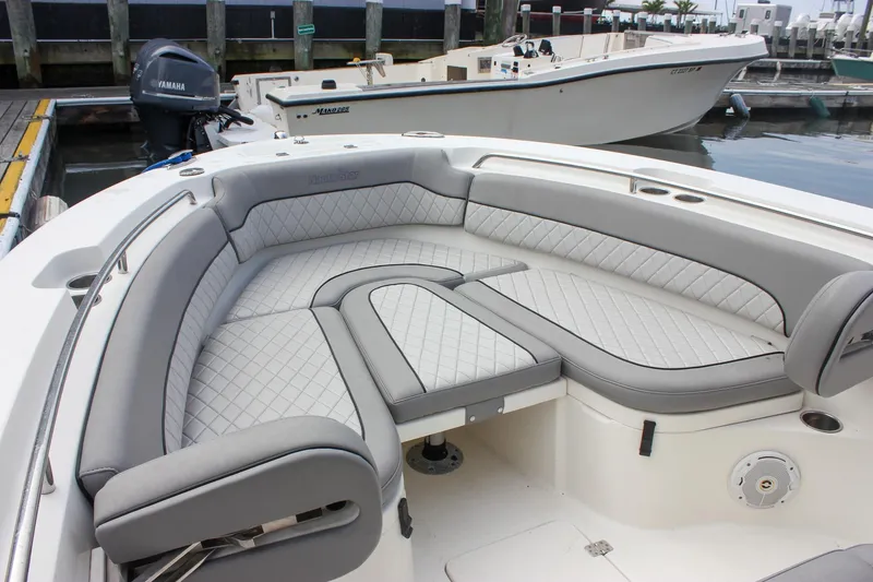 Slide: The Image of 2017 NauticStar 2602 Legacy boat console with rod holders and control panel. - 17