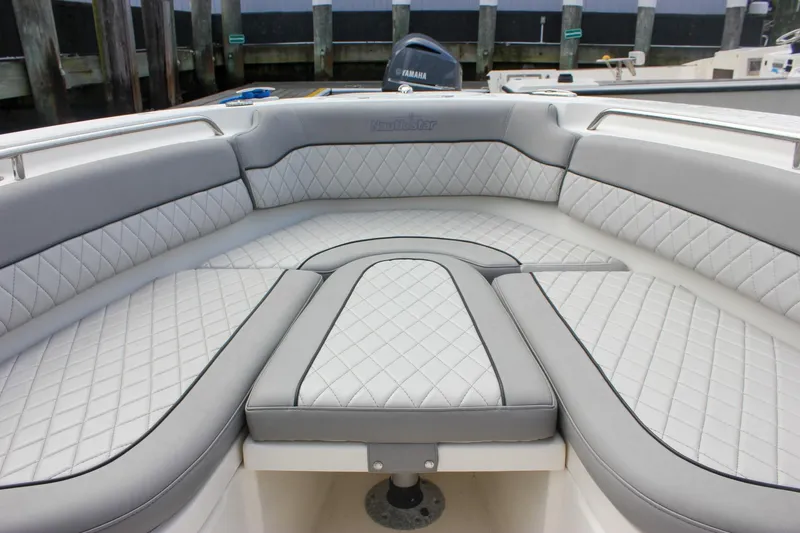 Slide: The Image of 2017 NauticStar 2602 Legacy boat seating with quilted upholstery and storage compartment. - 19
