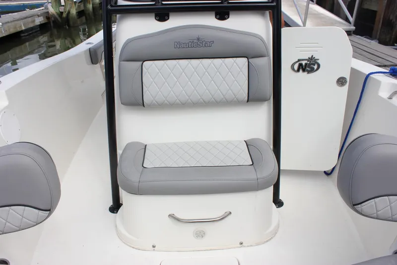 Slide: The Image of 2017 NauticStar 2602 Legacy boat anchor compartment with chain and winch. - 25