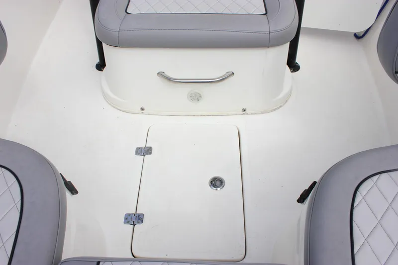 Slide: The Image of 2017 NauticStar 2602 Legacy boat interior with cushioned seating and storage. - 26