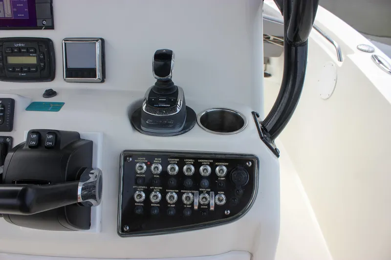 Slide: The Image of 2017 NauticStar 2602 Legacy boat dashboard with steering wheel and navigation controls. - 29
