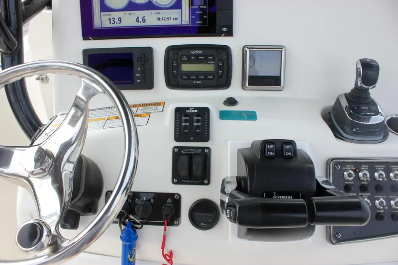 Slide: The Image of Control panel of 2017 NauticStar 2602 Legacy boat with switches and throttle. - 30