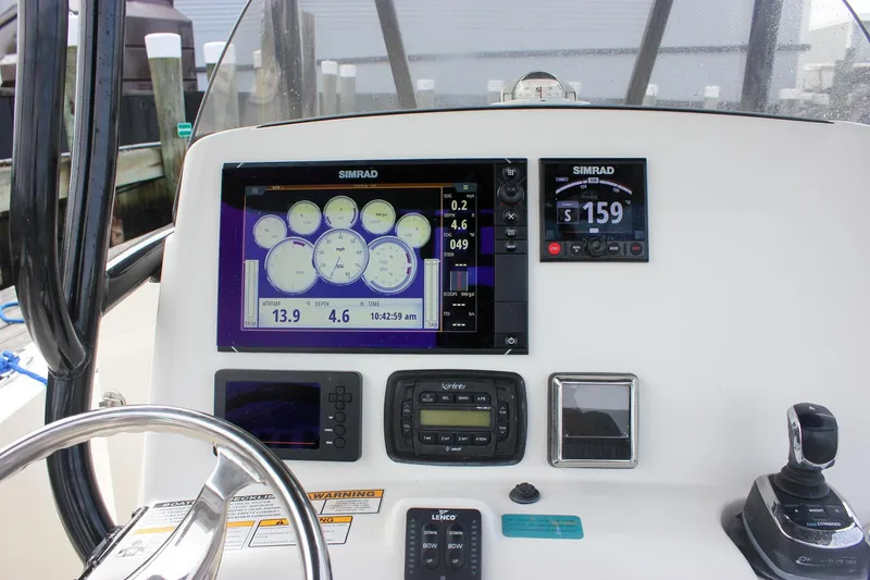 Slide: The Image of Control panel of 2017 NauticStar 2602 Legacy boat with steering wheel and navigation instruments. - 31