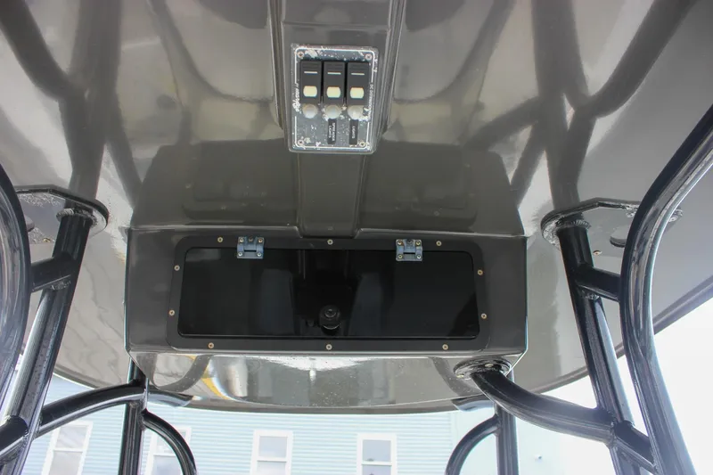 Slide: The Image of 2017 NauticStar 2602 Legacy boat dashboard with Simrad navigation displays. - 32