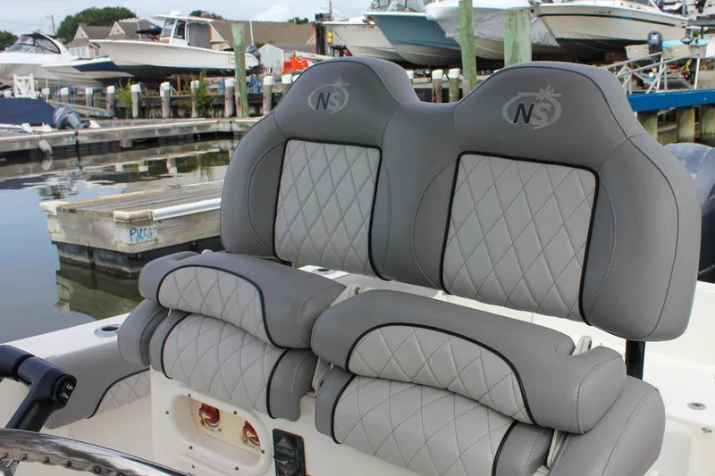 Slide: The Image of 2017 NauticStar 2602 Legacy boat console with controls and branding. - 34