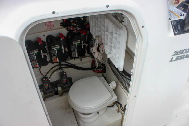 Slide: The Image of 2017 NauticStar 2602 Legacy boat interior with batteries and marine toilet. - 41