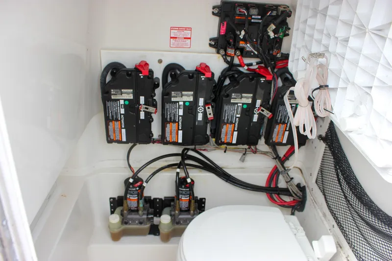 Slide: The Image of 2017 NauticStar 2602 Legacy boat interior with toilet and battery compartment. - 42