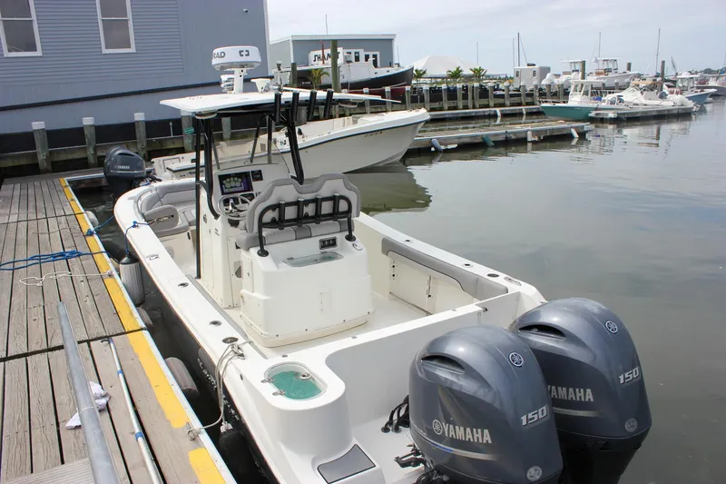 Slide: The Image of 2017 NauticStar 2602 Legacy boat docked at a marina with other vessels. - 45