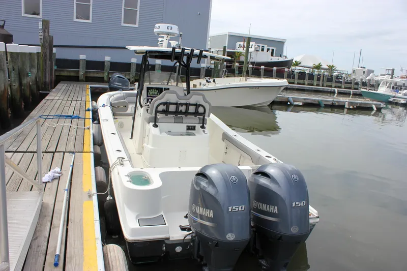 Slide: The Image of 2017 NauticStar 2602 Legacy boat docked with twin Yamaha 150 engines. - 46