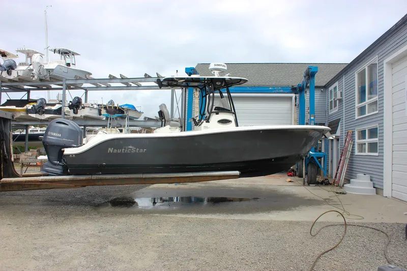 Slide: The Image of 2017 NauticStar 2602 Legacy boat docked with twin Yamaha 150 engines. - 47