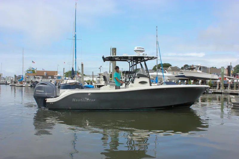 Slide: The Image of 2017 NauticStar 2602 Legacy boat docked in a marina, featuring Yamaha outboard engine. - 50
